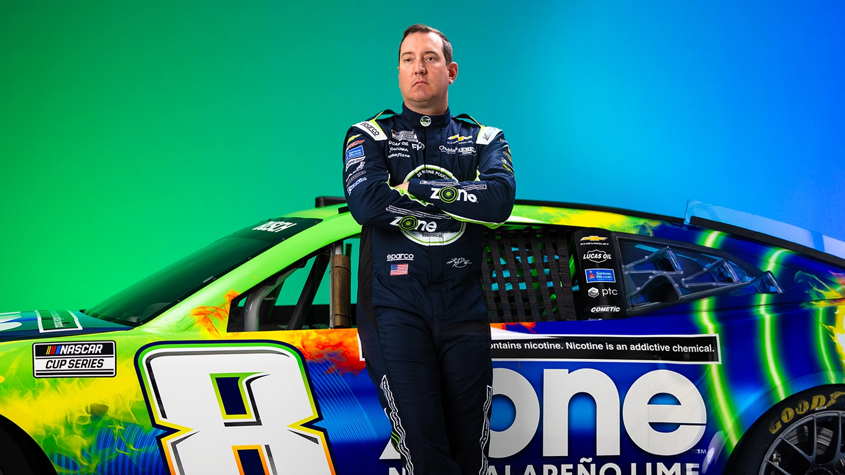 Kyle Busch standing in front of the Zone Nascar Car