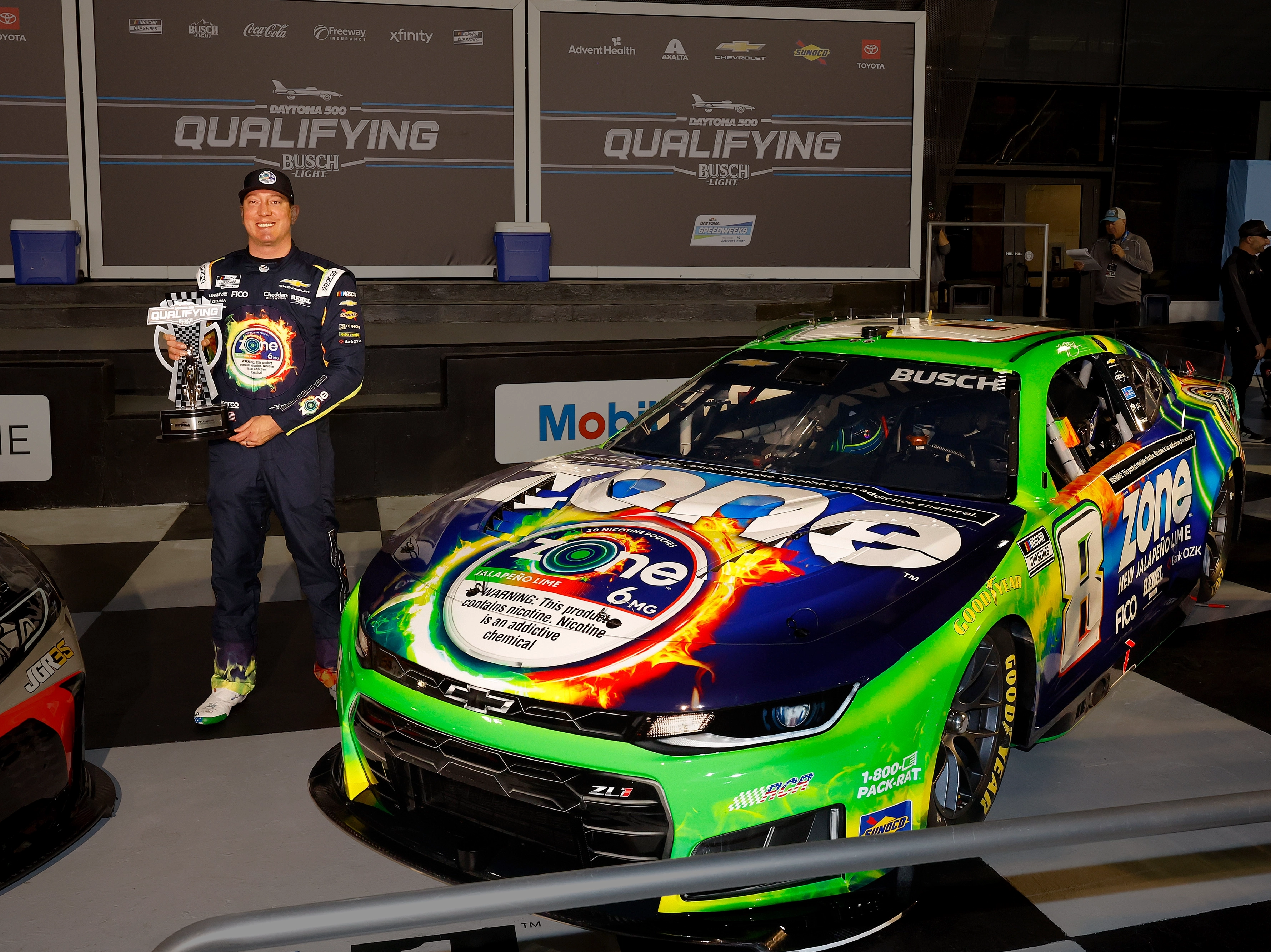 Kyle Busch with a trophy next to the zone #8 car